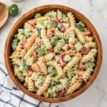 Creamy Ranch Pasta Salad with tri color rotini and crisp broccoli in a wooden bowl